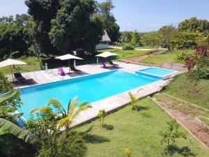 an image of a swimming pool in a garden at Greengardenlodge in Nosy Be