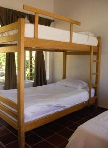 two bunk beds in a room with a window at Villa Celia Casa Campo in Pueblo Bello +23 photos
