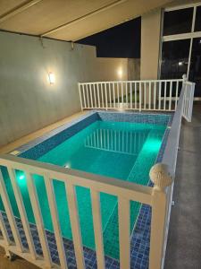 a large swimming pool with a white rail around it at TiDise Villas & Chalets إستراحة وشاليه تايدايس in Bimmah