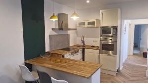 a kitchen with white appliances and a wooden counter top at Historische Villa mit Drachenfels-Blick in Bad Honnef am Rhein