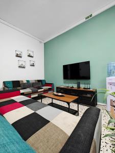 a living room with couches and a flat screen tv at Cosy room 5 in Tal-Pietà +17 photos