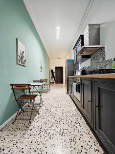 a kitchen with a table and chairs in a room at Cosy room 5 in Tal-Pietà