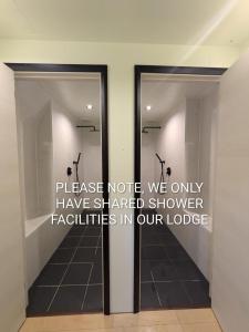 a room with two glass doors with the words please note we only have shared shower at The Nook Hakuba in Hakuba