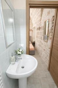 a bathroom with a white sink and a mirror at Dimora delle Badesse in Conversano +34 photos