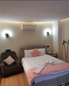a bedroom with a large bed and a chair at Sığacıksenkonukevi in Siğacık +11 photos