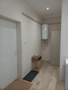 a room with a white wall and a wooden table at KOD VELIKIH TUJA in Melenci +20 photos