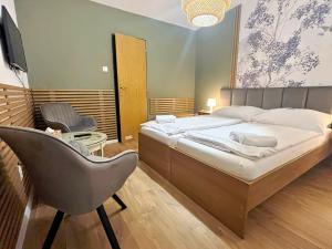 a bedroom with a bed and a chair in it at Antonio Old Town Residence in Prešov