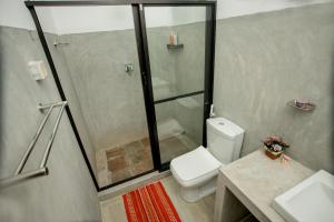 a bathroom with a shower and a toilet and a sink at Mystay in Kandy +31 photos
