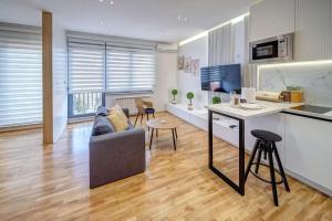a living room with a couch and a table at Jacuzzi Spa King Apartments FREE PARKING in Belgrade