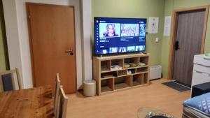 a living room with a flat screen tv and a table at Relax apartmá Brno central - Brno střed in Brno