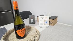 a bottle of wine in a basket on a table at Dom Hlohovec Center in Hlohovec