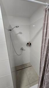 a shower with a shower curtain in a bathroom at Dom Hlohovec Center in Hlohovec +27 photos