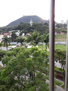 a view of a city from a window with trees at Tranquility with convenience in Caxambú Tranquilo in Caxambu