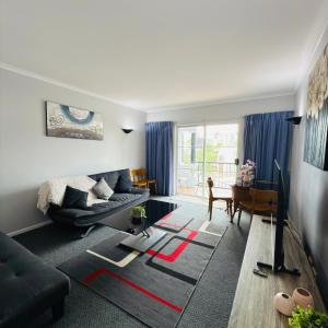 a living room with a couch and a table at Villa on Grafton in Cairns