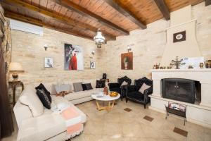 a living room with a couch and a fireplace at Villa Marcos Chara in Astérion