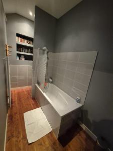 a bathroom with a white tub in a room at Le balcon de Vernay in Vernay +15 photos