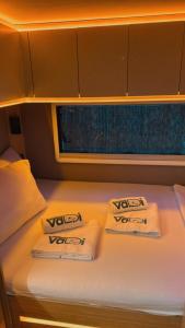 a bedroom with two towels on a bed with a window at Vadi Karavan Otel in Buca +5 photos