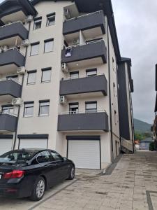 a black car parked in front of a building at Onix 1 in Soko Banja