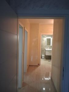 a hallway with a bathroom and a sink at Onix 1 in Soko Banja +30 photos
