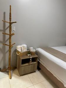 a bedroom with a bed and a wooden stand with towels at Casa Maresia Ponta da Asa in Coruripe +27 photos
