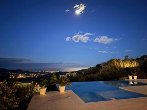 a villa with a swimming pool at night at Villa Ebe - Luxury Villa with sea view in Acquaviva Picena