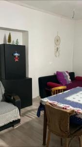 a living room with a table and a couch at Old Guesthouse Tsikhisdziri in Tsikhisdziri