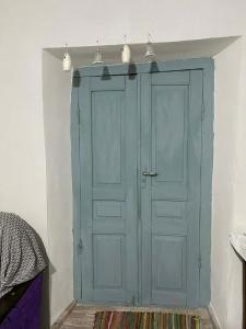 a blue cabinet with two lights on top of it at Old Guesthouse Tsikhisdziri in Tsikhisdziri
