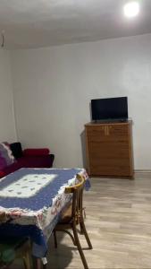 a room with a bed and a dresser with a tv at Old Guesthouse Tsikhisdziri in Tsikhisdziri +2 photos
