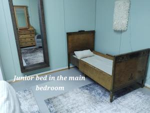a bed in a room with a mirror and a mirror bed in the main bedroom at Raanu Apartment 45 minutes from Rovaniemi center in Raanujärvi