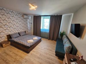 a living room with a bed and a couch at къща Чипровка in Chiprovtsi