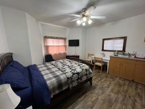 a bedroom with a bed and a sink and a ceiling fan at Malden Studio near Boston -- Private Stay with Kitchenette, Laundry in Malden