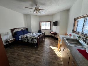 a bedroom with a bed and a kitchen with a sink at Malden Studio near Boston -- Private Stay with Kitchenette, Laundry in Malden