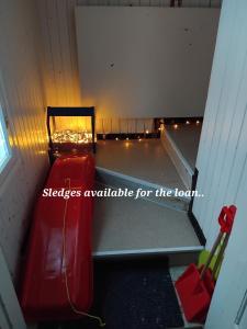 a red bench in a room with lights at Raanu Apartment 45 minutes from Rovaniemi center in Raanujärvi +39 photos