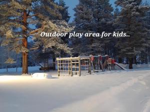 an outdoor play area for kids in the snow at Raanu Apartment 45 minutes from Rovaniemi center in Raanujärvi