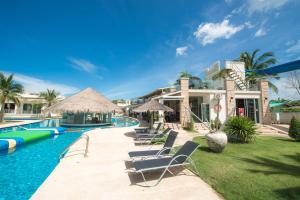 a house with a swimming pool with chairs in front of it at Oriental Beach Pearl Resort in Sam Roi Yot