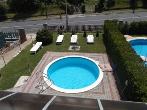 ein großer Pool mit zwei Stühlen und zwei Pools in der Unterkunft Livia Apartman in Balatonföldvár