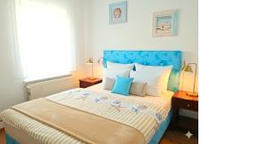 a bedroom with a blue and white bed with two lamps at Villa Meeresglück in Sassnitz
