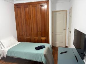 a bedroom with a bed with a wooden cabinet at casa cairasco in Las Lagunas