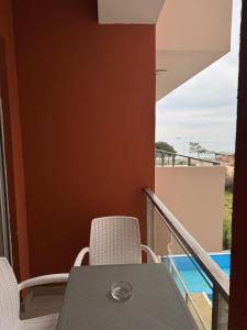 a balcony with a table and chairs with a view at Apartaments Shengjin with sea view in Shëngjin