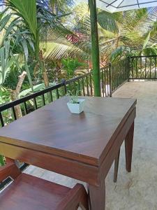 a wooden table with a potted plant sitting on it at Liora Cottage Ella in Ella