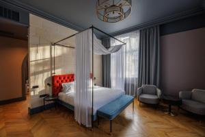 a bedroom with a bed with a canopy at Lion's Castle Hotel in Lviv