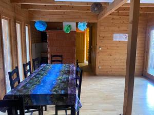 a dining room with a table with blue and green decorations at Hargitaház Mountain House in Harghita-Băi