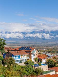 a town with buildings and mountains in the background at Matilda Signature Apartments in Telavi