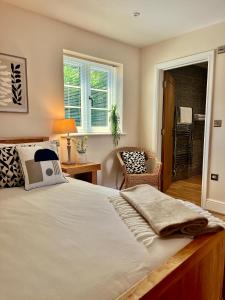 a bedroom with a large bed and a chair at The Dove in Knook