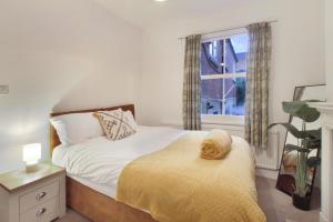 a bedroom with a bed and a window at town house in Northampton