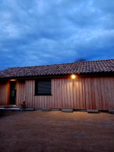 a building with a light on the side of it at Maison style chalet in Salles
