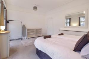 a white room with two beds and a chalkboard at town house in Northampton