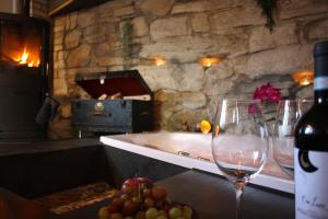a kitchen with a tub and a glass of wine at La Schaumauna, privater Spa in Oberkirch