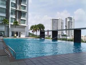 a large swimming pool in a city with tall buildings at peacehome 13a in Cyberjaya