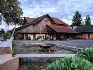 a large wooden building with a grill in front of it at La Schaumauna, privater Spa in Oberkirch